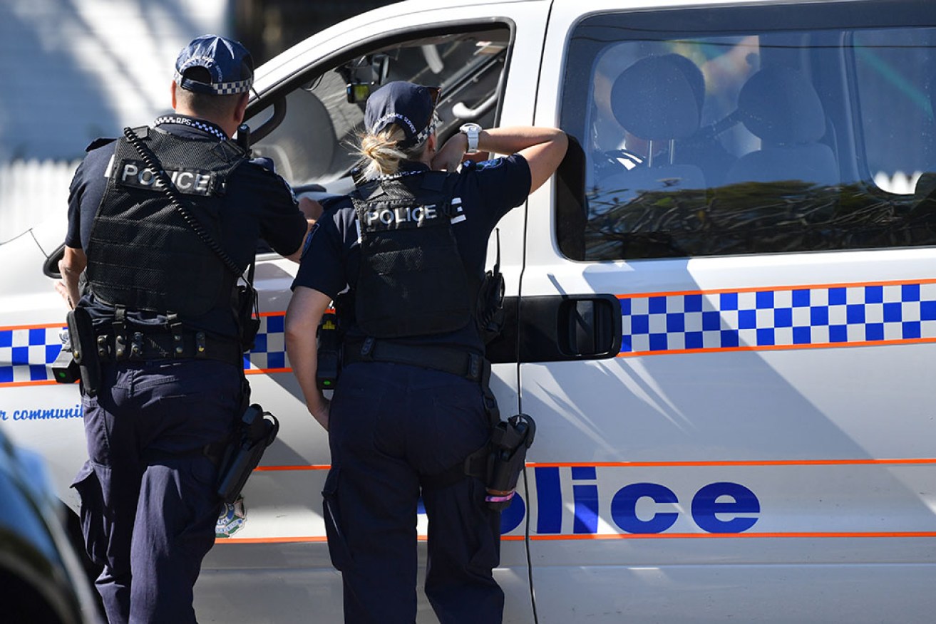 A police officer and a man both have gunshot wounds after an altercation at a Brisbane home.