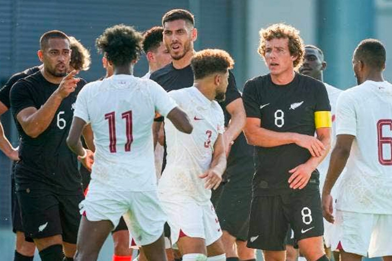 NZ players (wearing black) confront their Qatari opponents after Monday's incident.