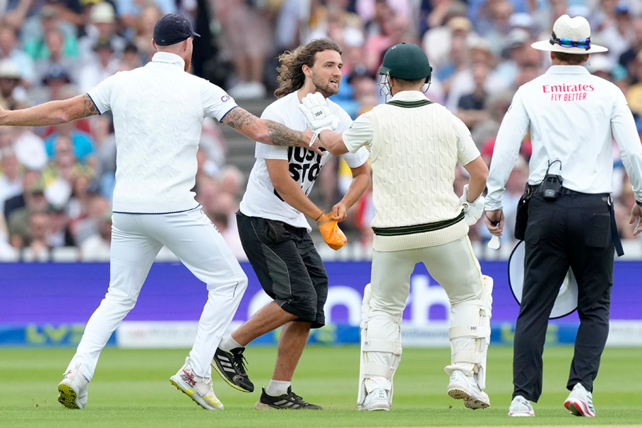 Ben Stokes and David Warner prevent a demonstrator from making his way to the pitch at Lord's. 