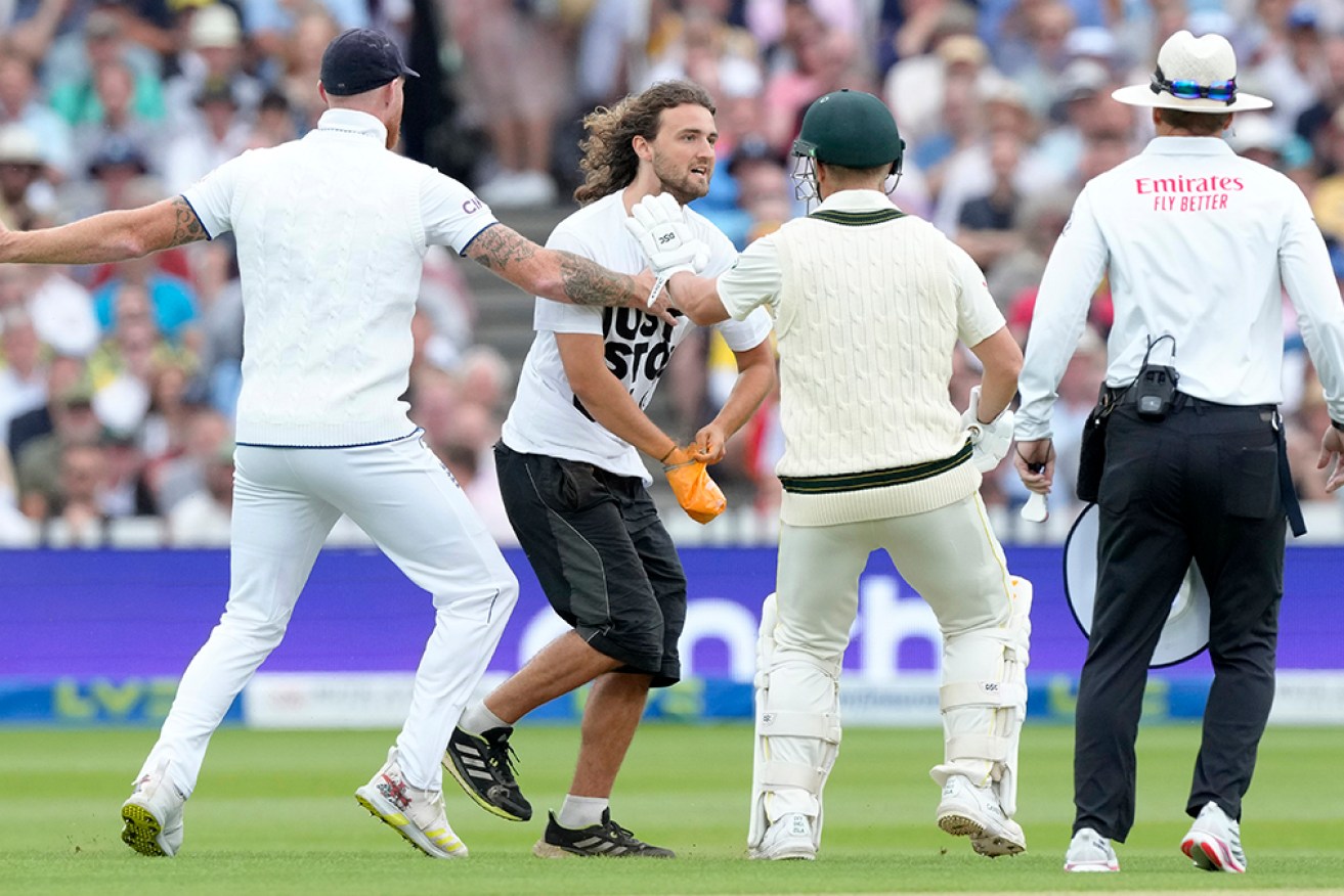 Ben Stokes and David Warner prevent a demonstrator from making his way to the pitch at Lord's.