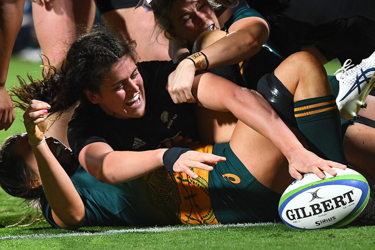 Chelsea Bremner scores in world champion New Zealand's 50-0 thrashing of the Wallaroos on Thursday.