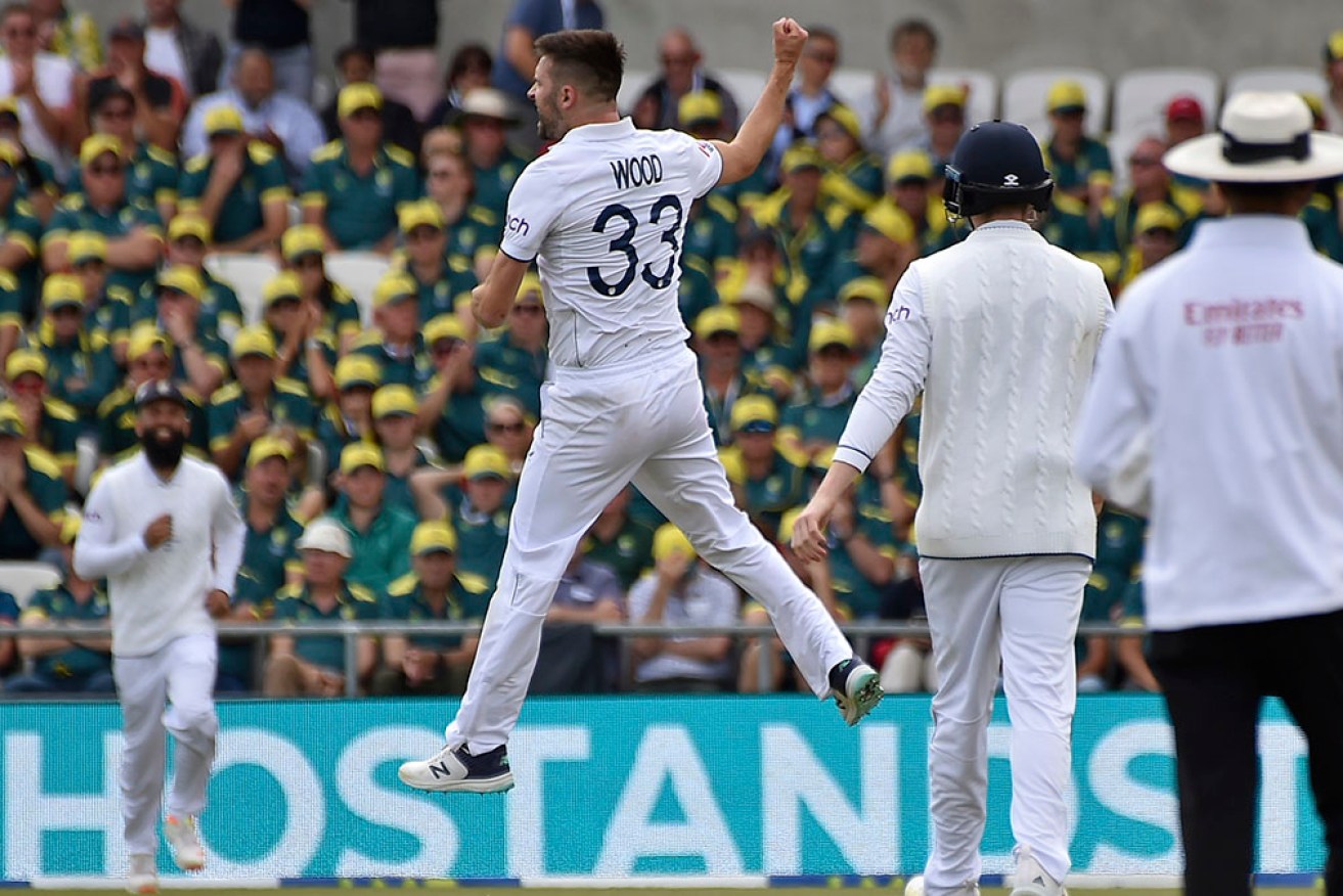 England's Mark Wood jumps to celebrate the dismissal of Australia’s Usman Khawaja in the third Test.