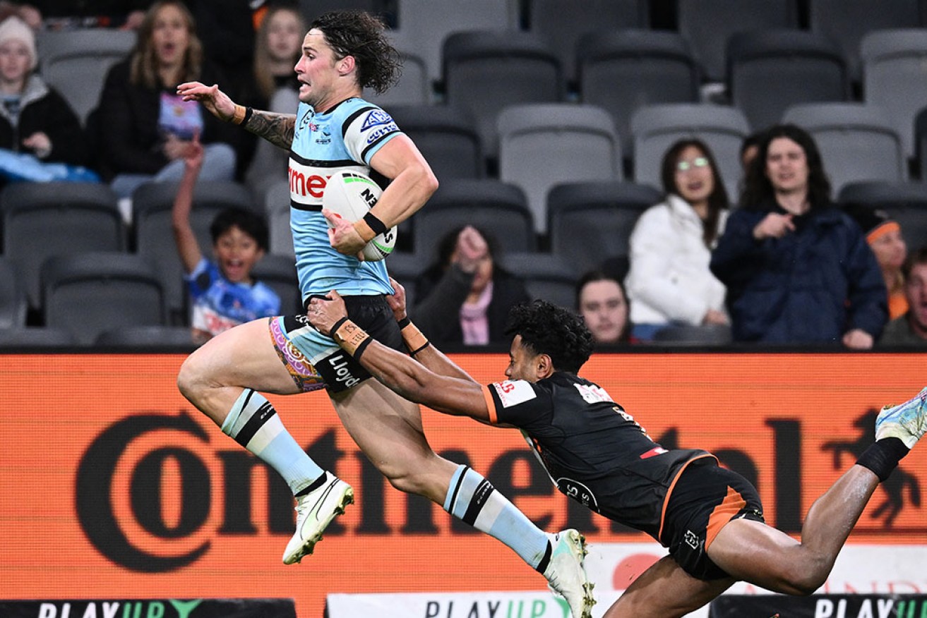 Nicho Hynes on his way to scoring a try in Cronulla's 36-12 win over Wests Tigers.