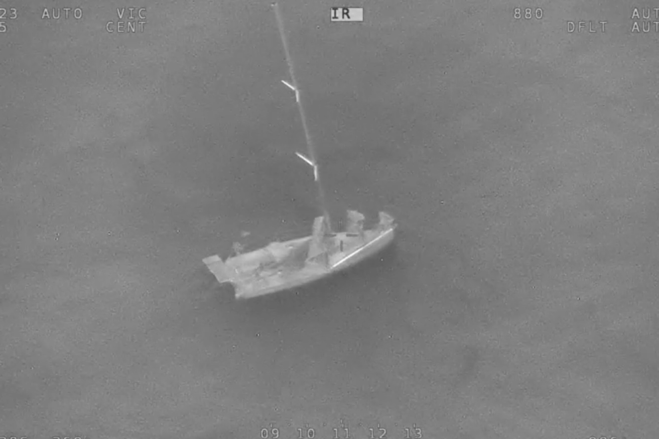 A tiny speck in a savage sea, the solo Bight yachtsman awaits rescue.
