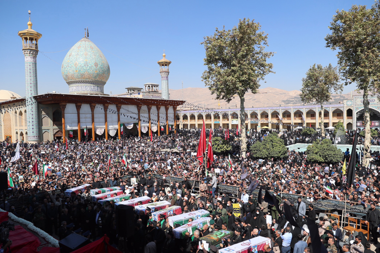 A massive crowd mourns the victims of October's mosque attack, which sent of the bombers to the gallows.