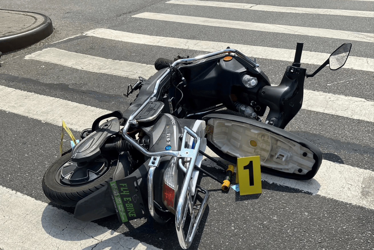 Marked with a yellow evidence tag, the gunman's scooter lies where the NYPD ended his rampage.