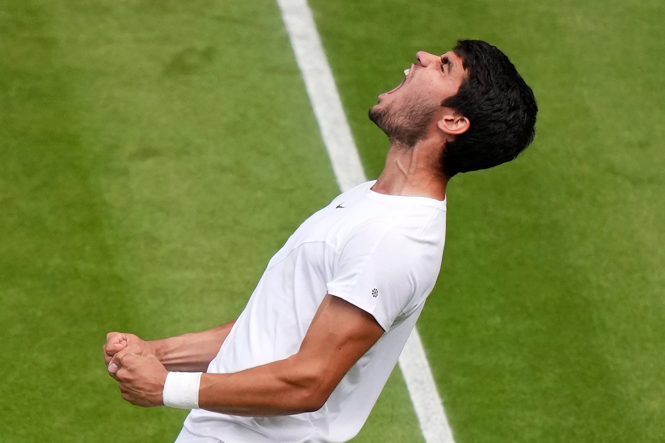 Carlos Alcaraz lets out a primal roar after winning his Wimbledon quarter-final with Holger Rune.
