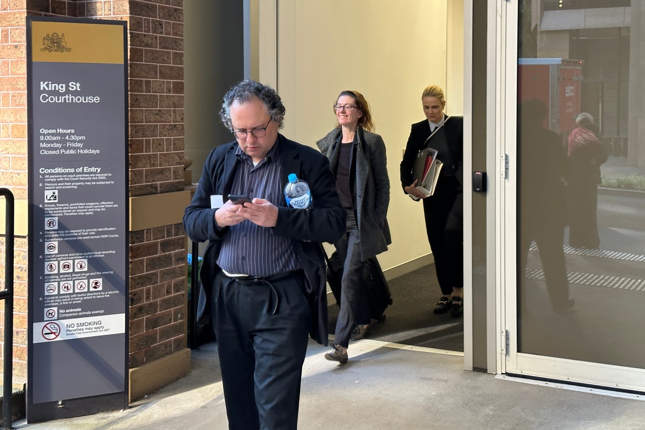 Jonatan Kelu and his lawyers leave King Street Courthouse in Sydney, on Thursday.