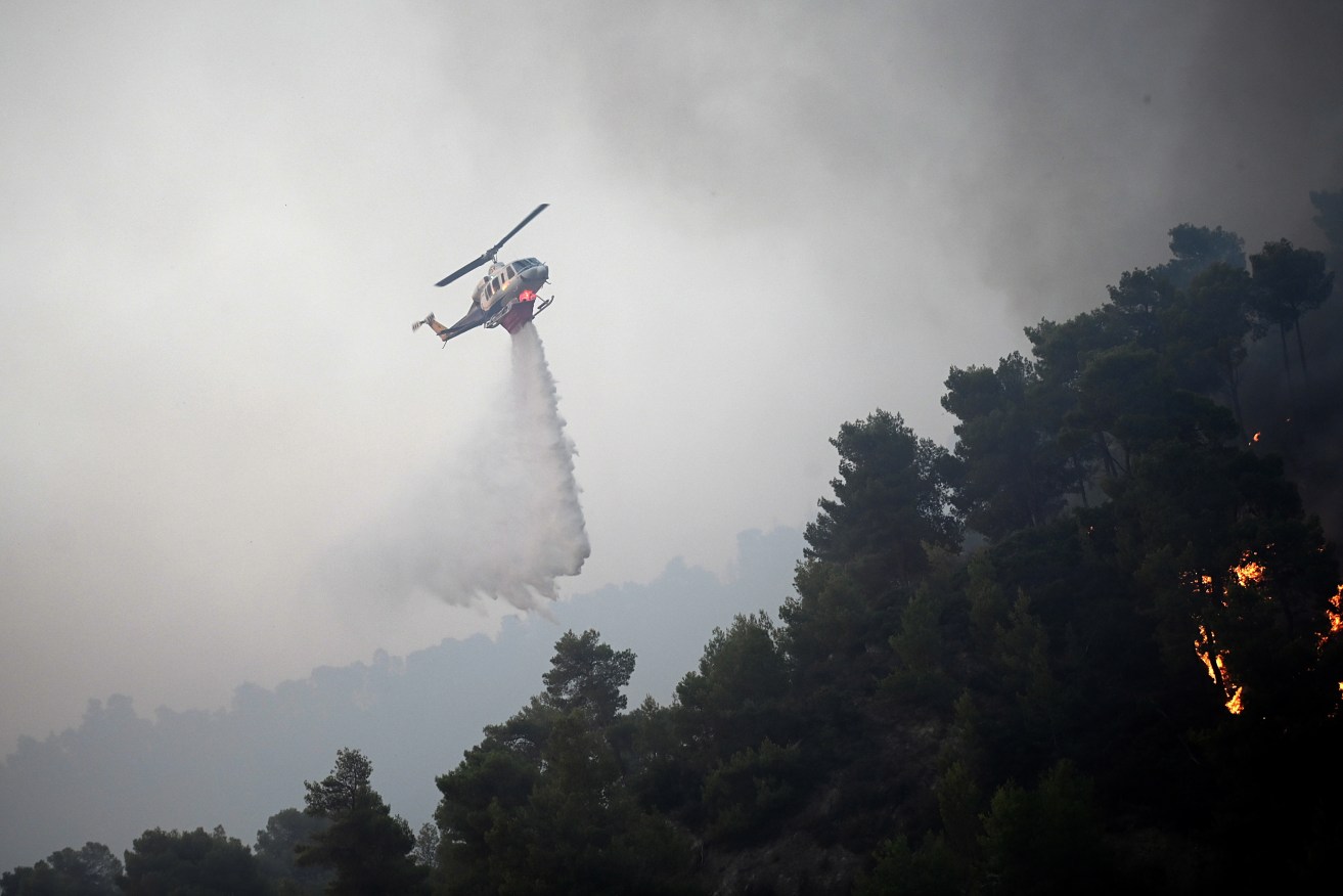 Dozens of wildfires torched Greece after days of extreme temperatures.  