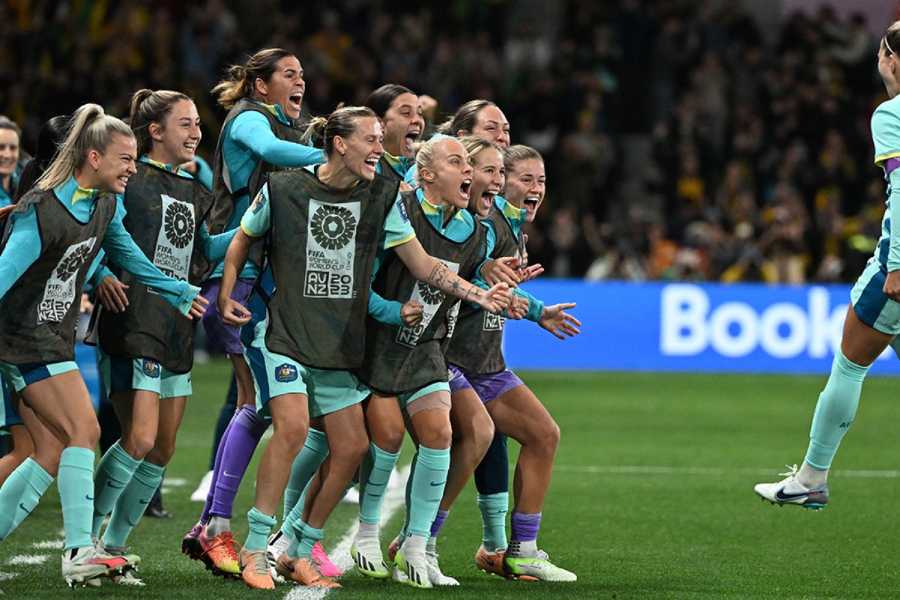 Steph Catley celebrates with teammates after her penalty against Canada in Melbourne.