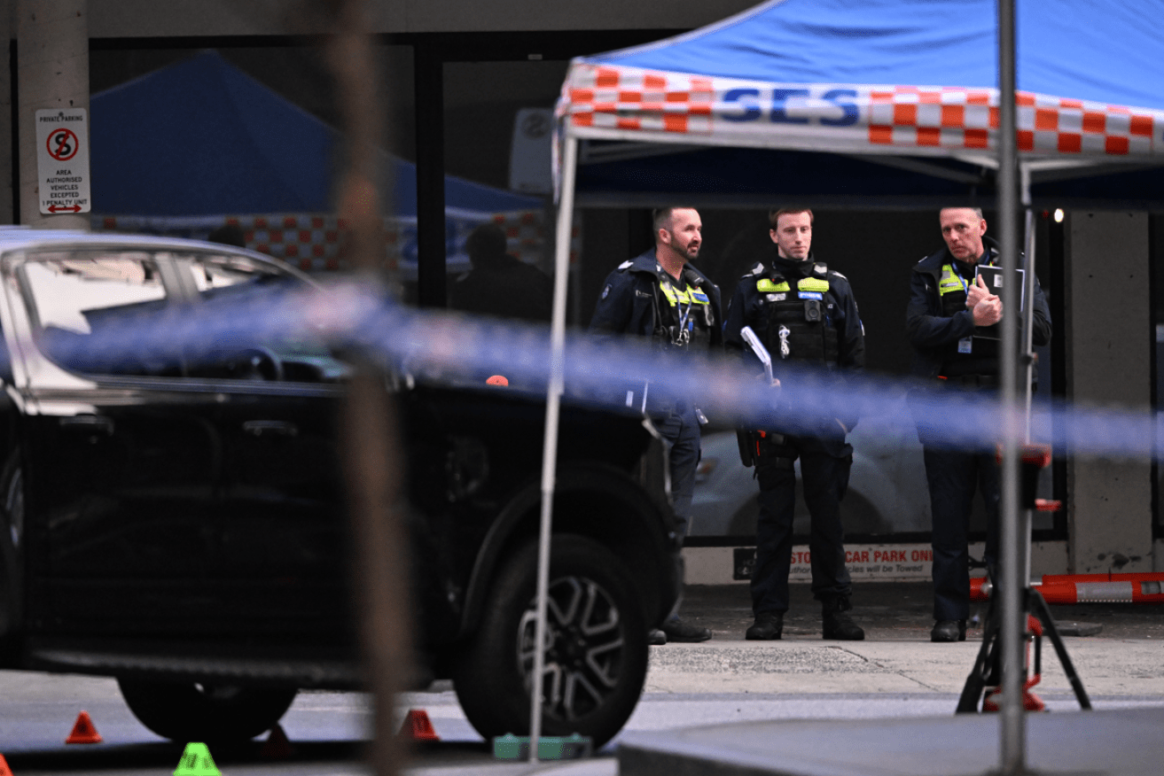Police guard the South Yarra scene of the gangland assassination.