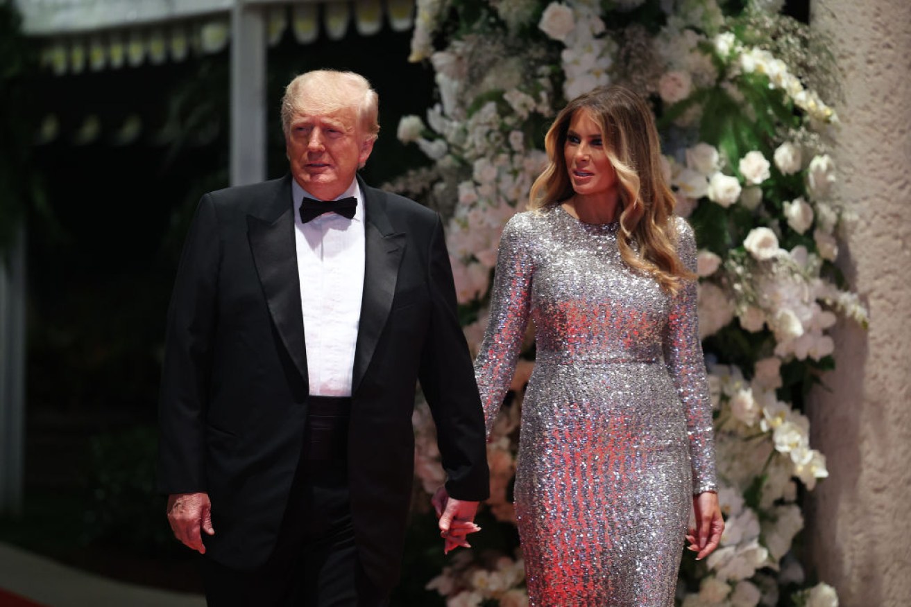 Donald and Melania Trump are cheered as they arrive at Mar-A-Lago ballroom on New Year’s Eve.