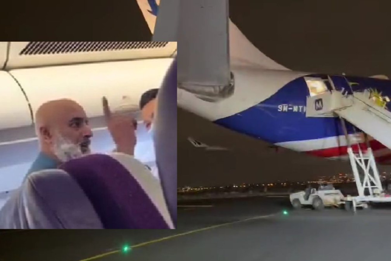 A man charged over alleged bomb threats on a plane refused to leave his police cell to attend court.