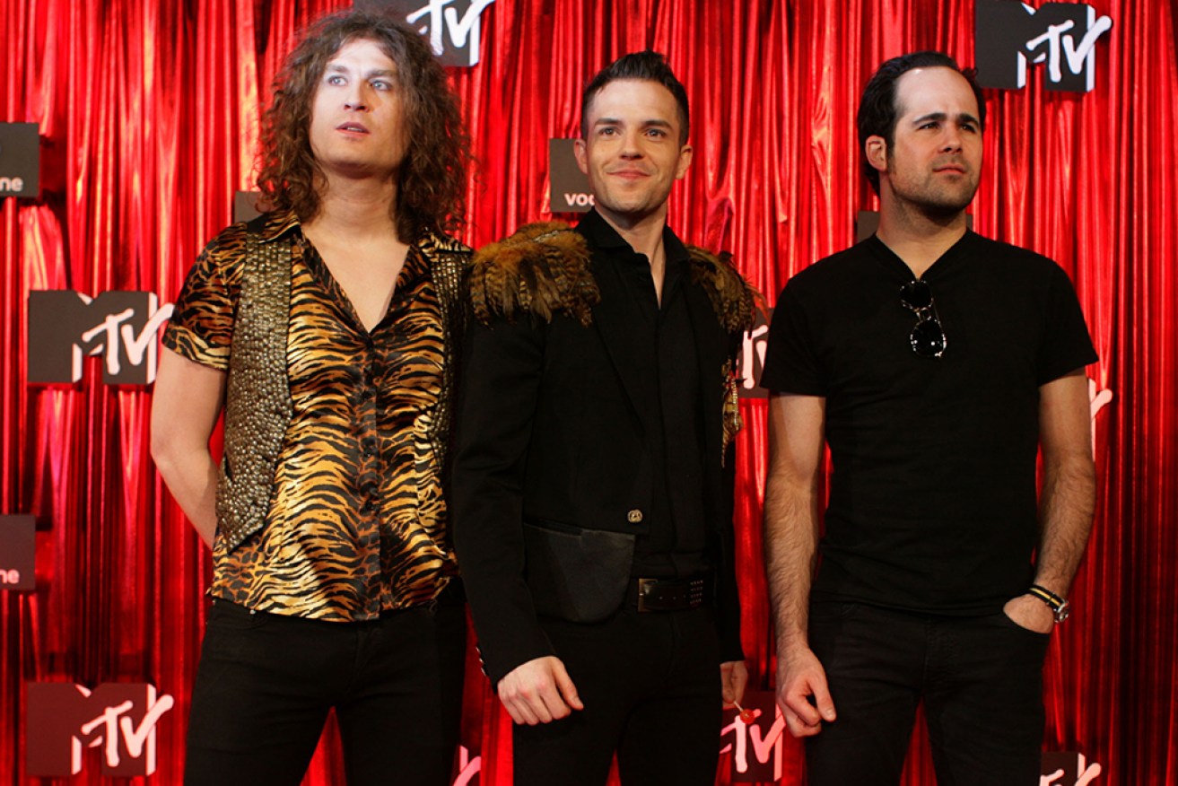 The Killers have apologised after inviting a Russian fan on stage during a concert in Georgia.