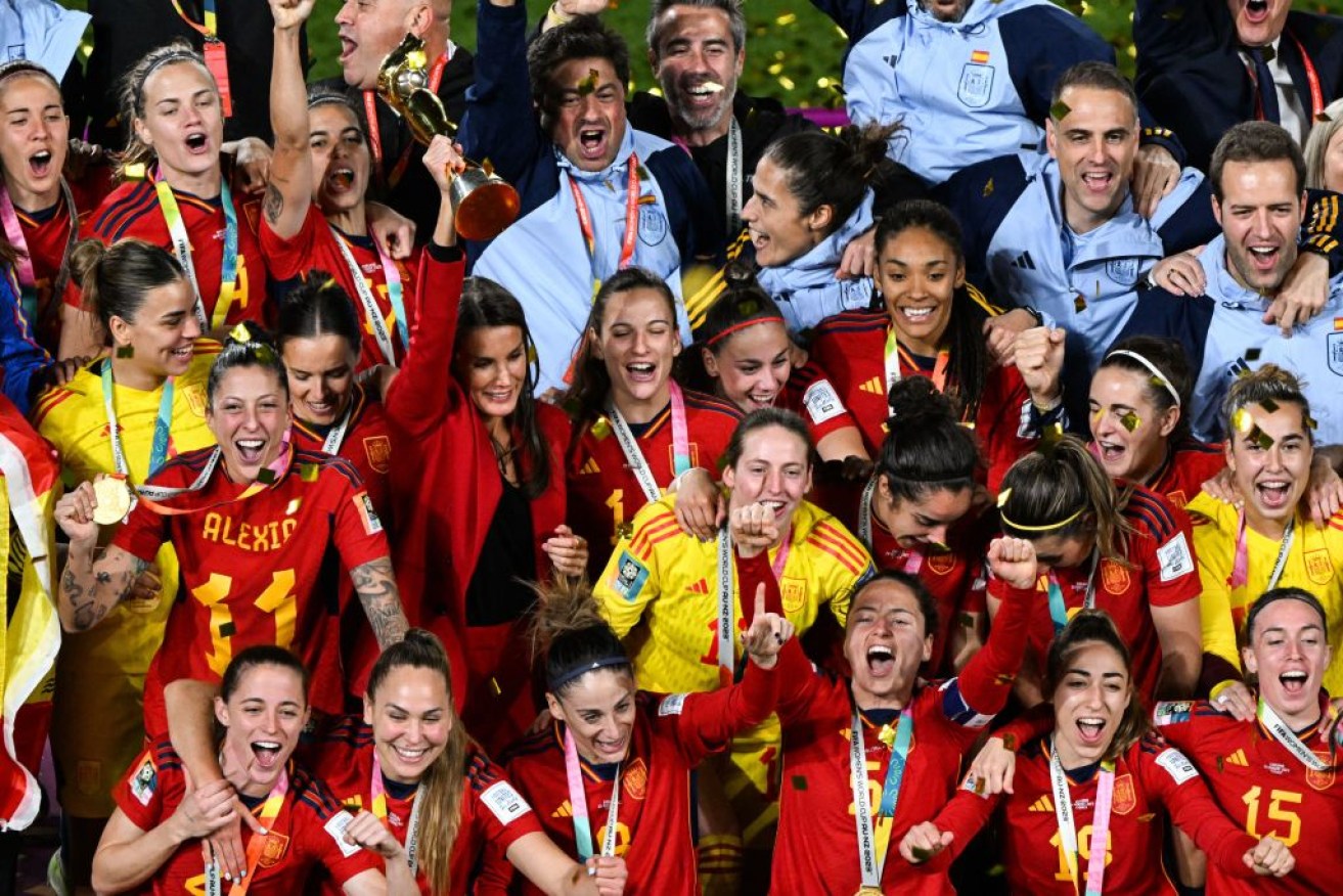 Queen Letizia of Spain lifts the trophy on the podium in celebration after Spain won the Australia and New Zealand 2023 Women's World Cup final football match between Spain and England in Sydney. 