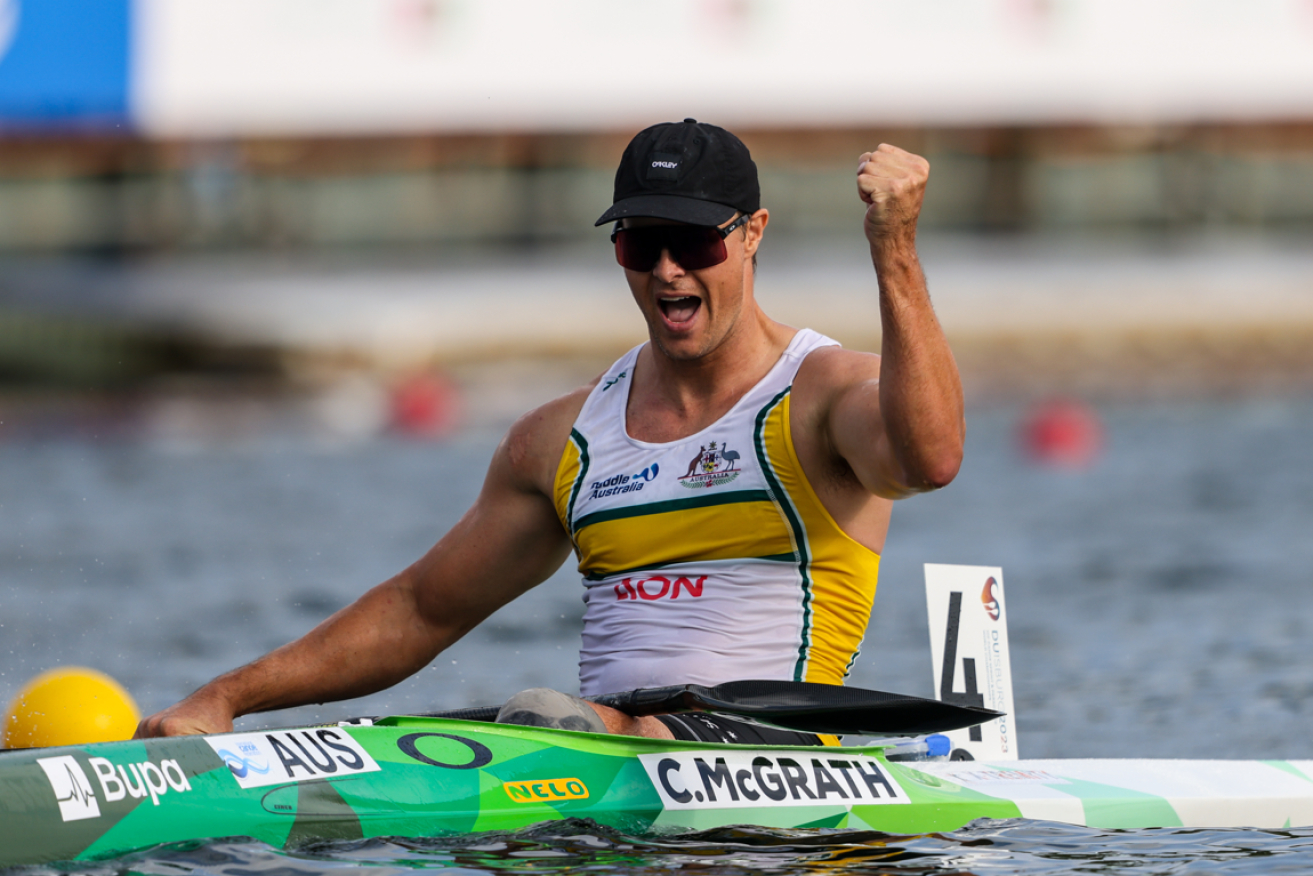 Curtis McGrath raising a fist in triumph after claiming his 11th world championships gold.