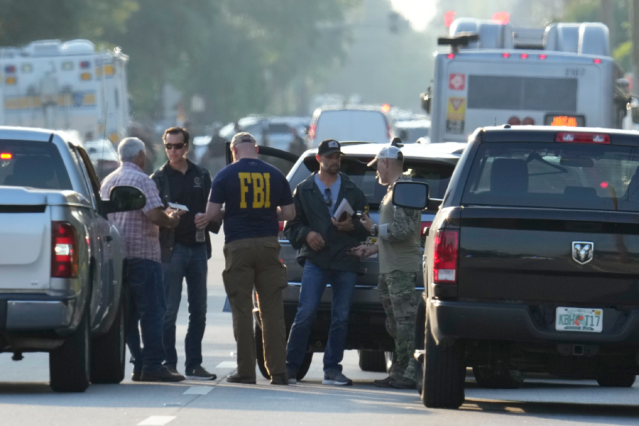 Another day in the US: Police converge on the scene of an August slaughter in Jacksonville, Florida.
