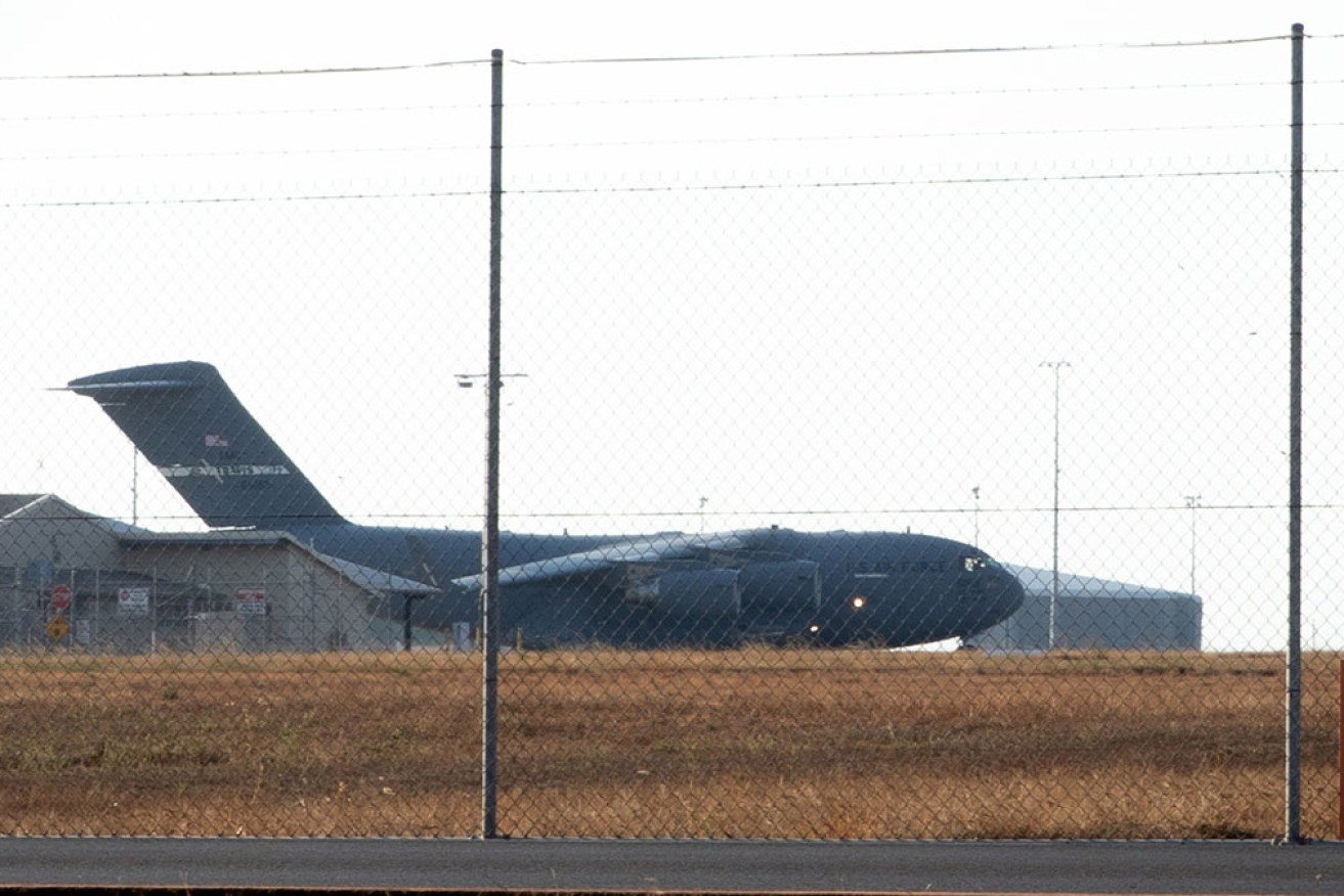 A US Air Force plane leaves Darwin with the bodies of three US marines killed in an aircraft crash.