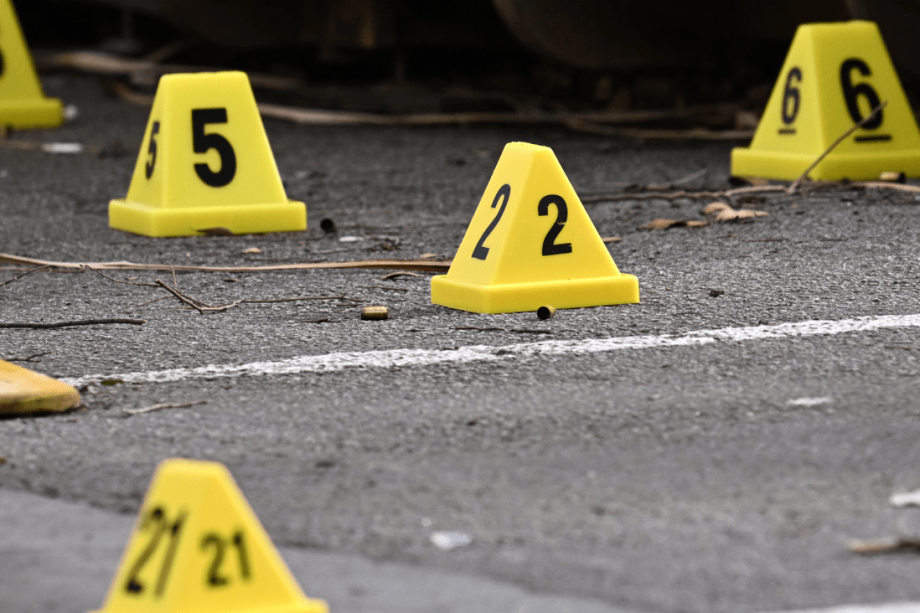 Numbered markers record where ejected shells fell when the black-clad assassins opened fire.