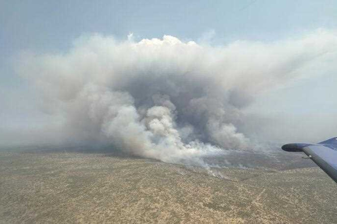 An anxious wait continues for the 3000 residents of Tenant Creek as a mega-blaze looms on the outskirts of the town.