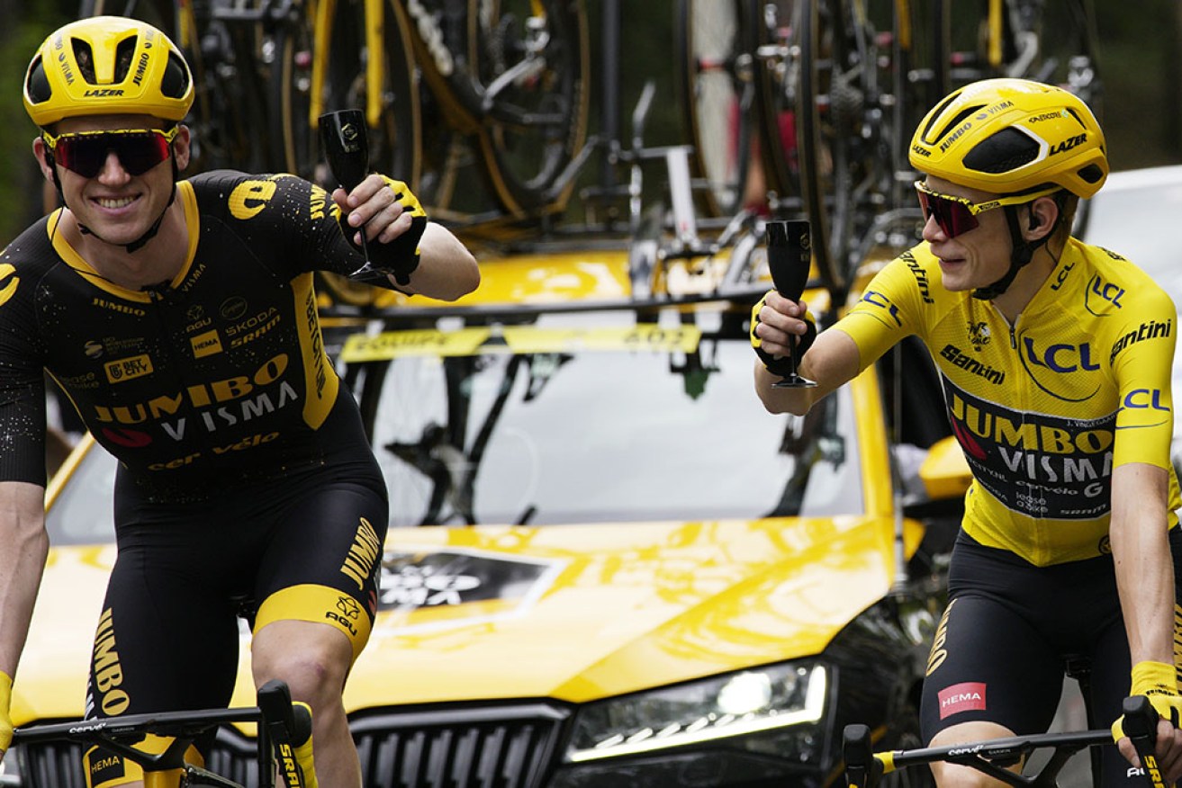 Nathan van Hooydonck, left, toasts the Tour de France win of Jumbo-Visma teammate Jonas Vingegaard. 