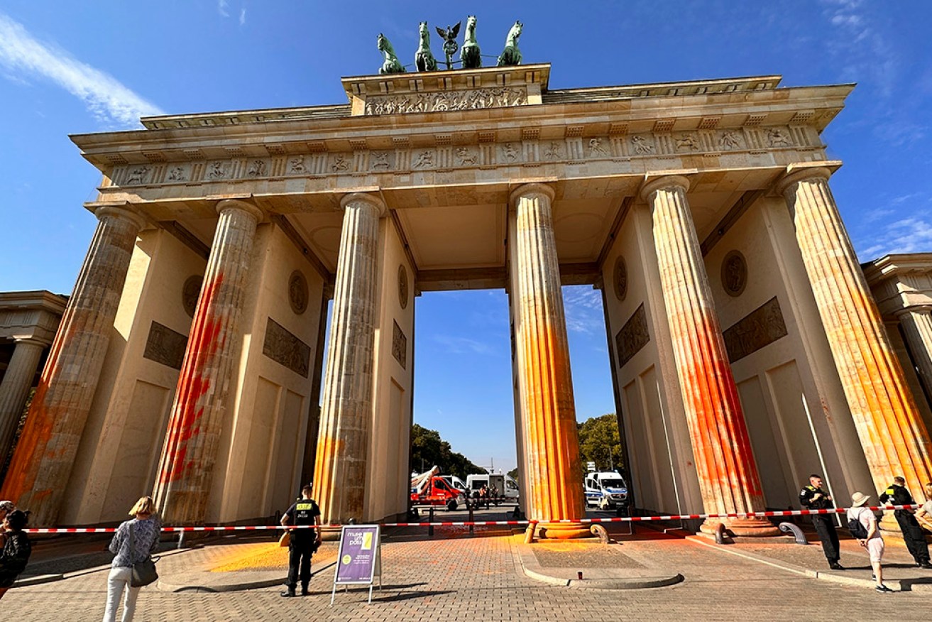 Climate activists have used fire extinguishers to spray paint the columns of the Brandenburg Gate.
