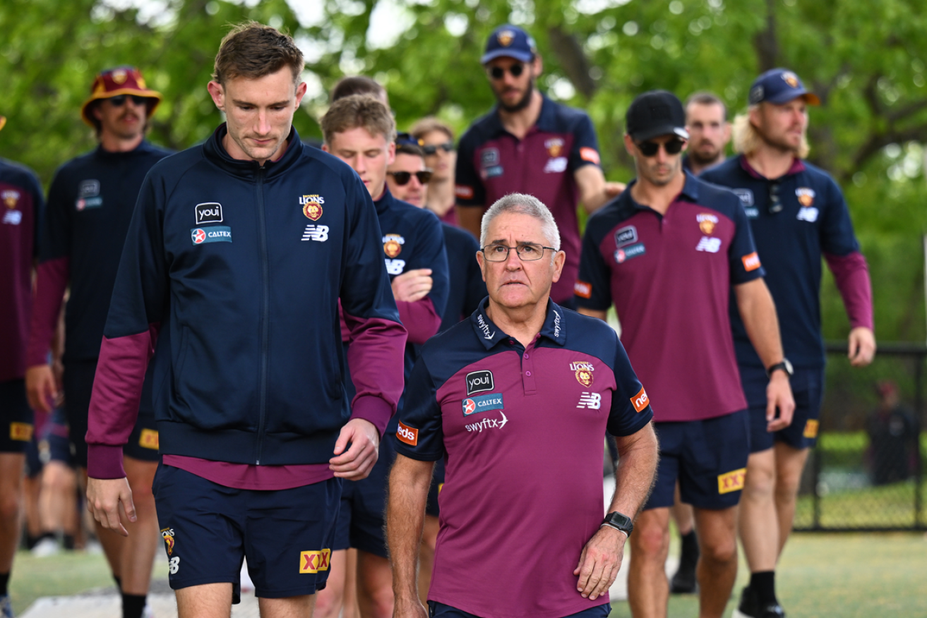 Coach Chris Fagan's expression says it all as he leads the Lions back to their Brisbane den.
