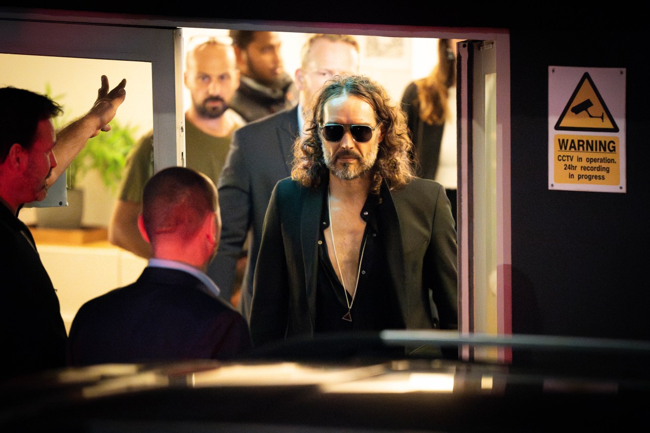 Russell Brand leaves a London theatre after a comedy performance, as allegations against him emerged.