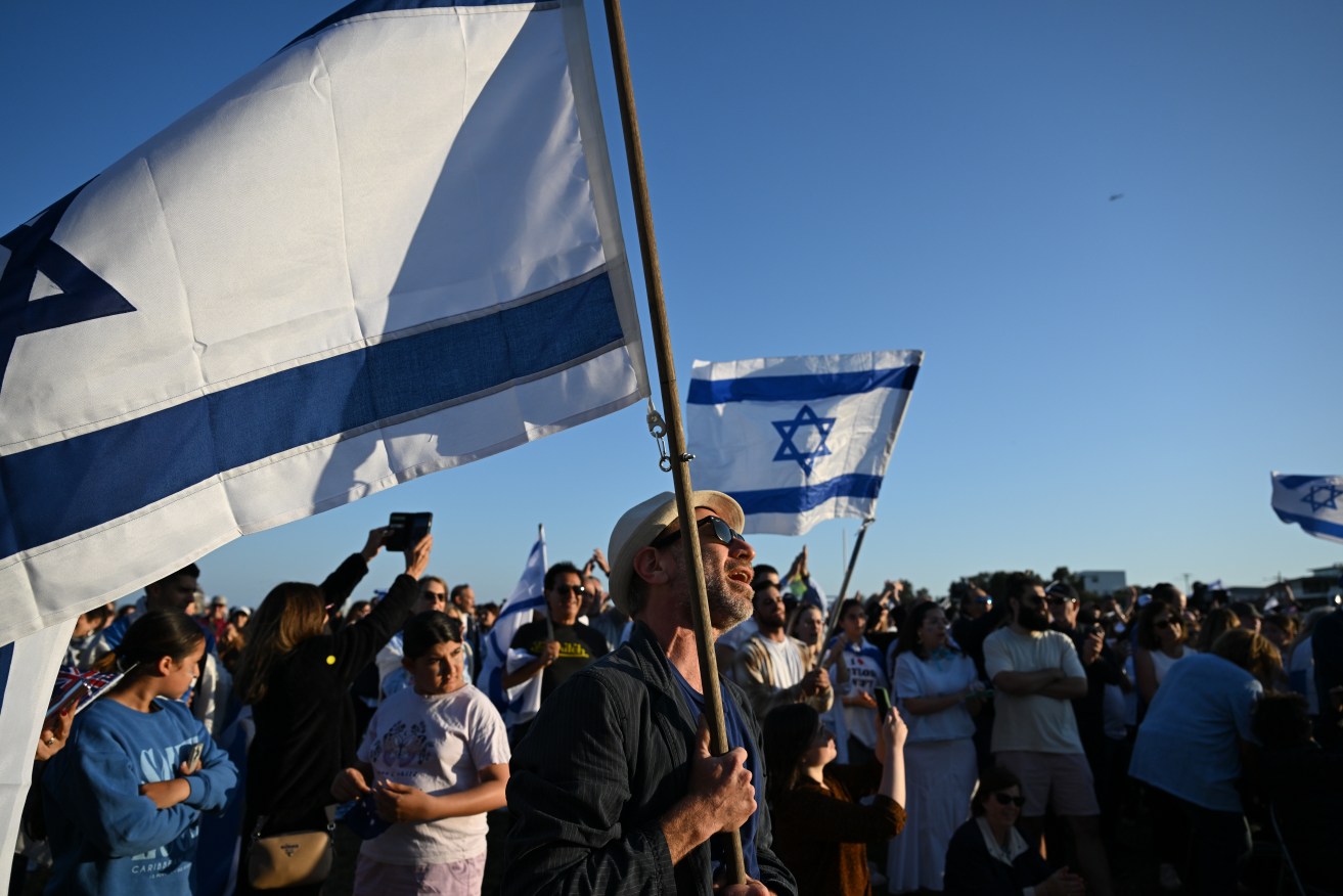 People attend a vigil for Israeli victims of Hamas at Rodney Reserve in Sydney.