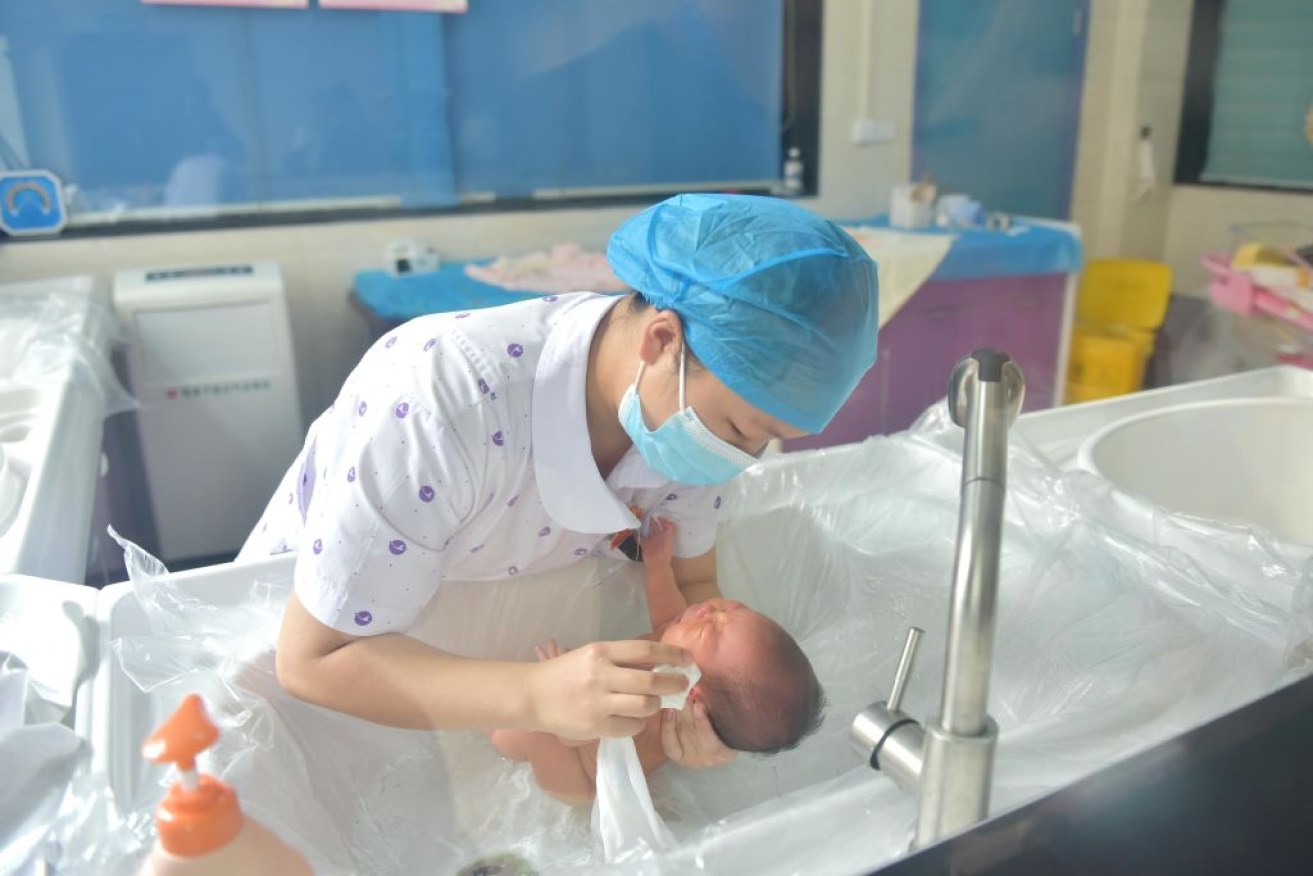 A baby has its first bath at the Congjiang County Maternal and Child Health Care Hospital in China's Guizhou's province.