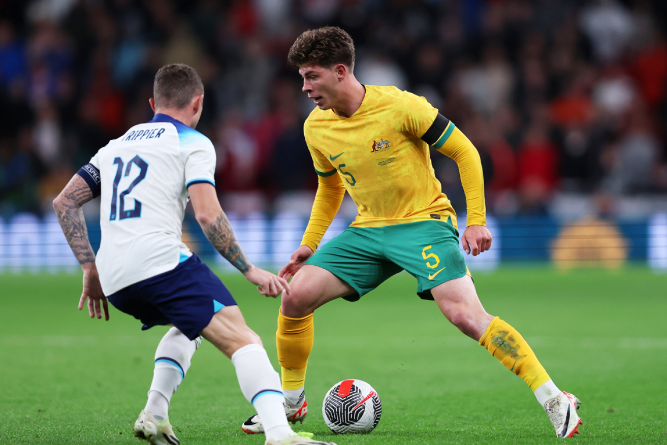Australia's Jordan Bos contends with defender Kieran Trippier of England during the international friendly at Wembley Stadium.