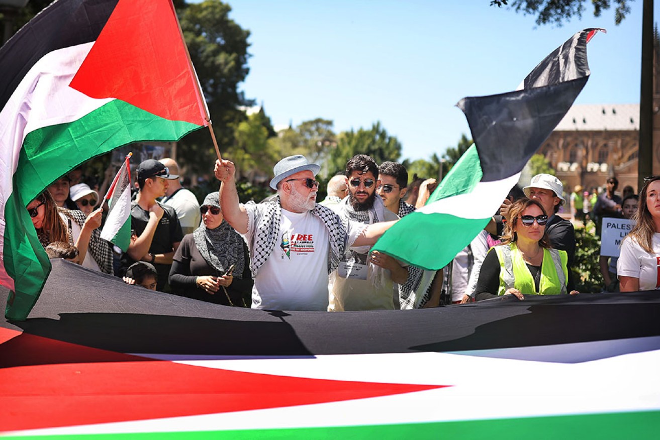 A man waves the Palestinian flag during a protest in support of Palestinians in Sydney on Sunday.