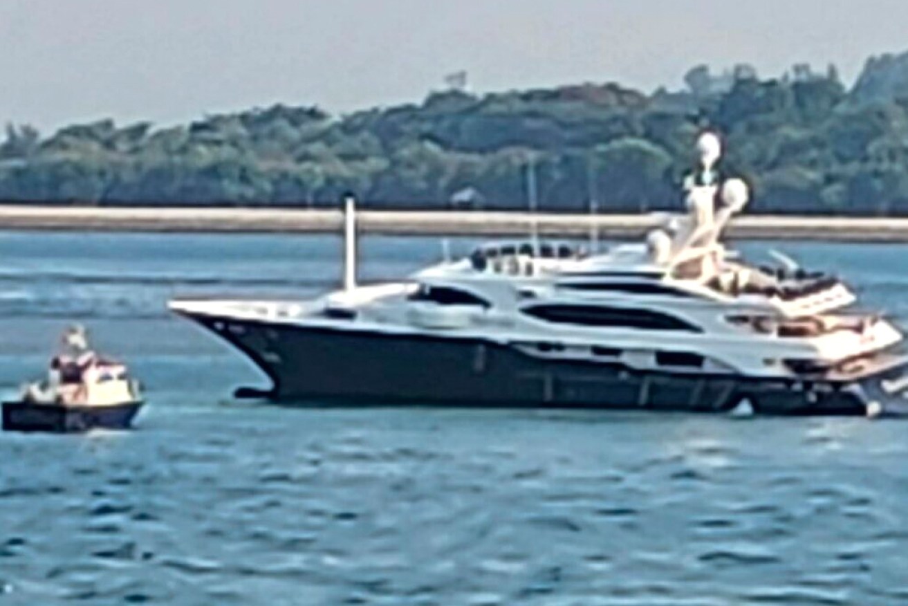 Palmer's luxury yacht Australia is stuck on a Singapore reef.