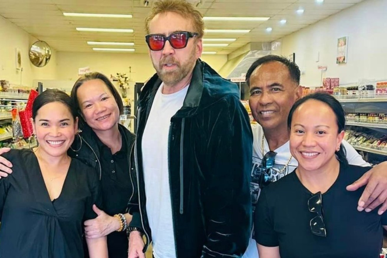 Oscar-winning star Nicolas Cage poses with staff at Food of Asia in Busselton. 