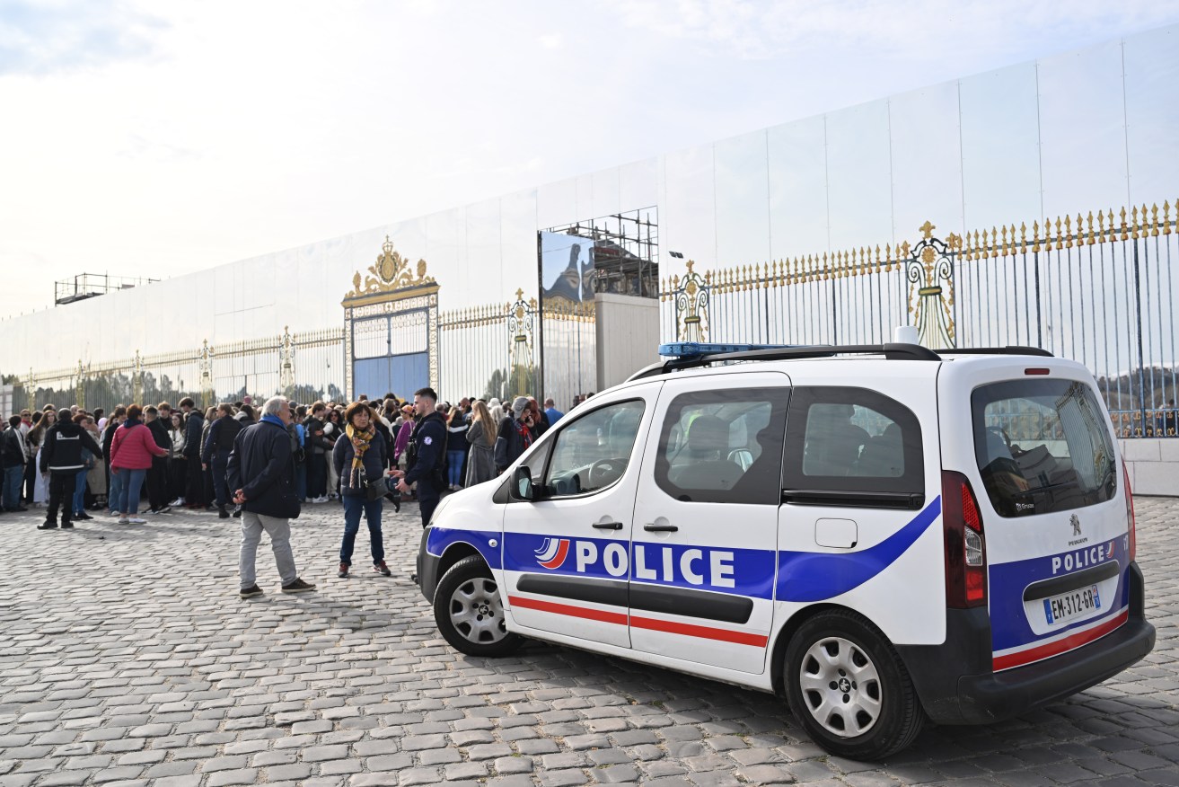 French police officers guard the entrance of the Palace of Versailles after a security alert.