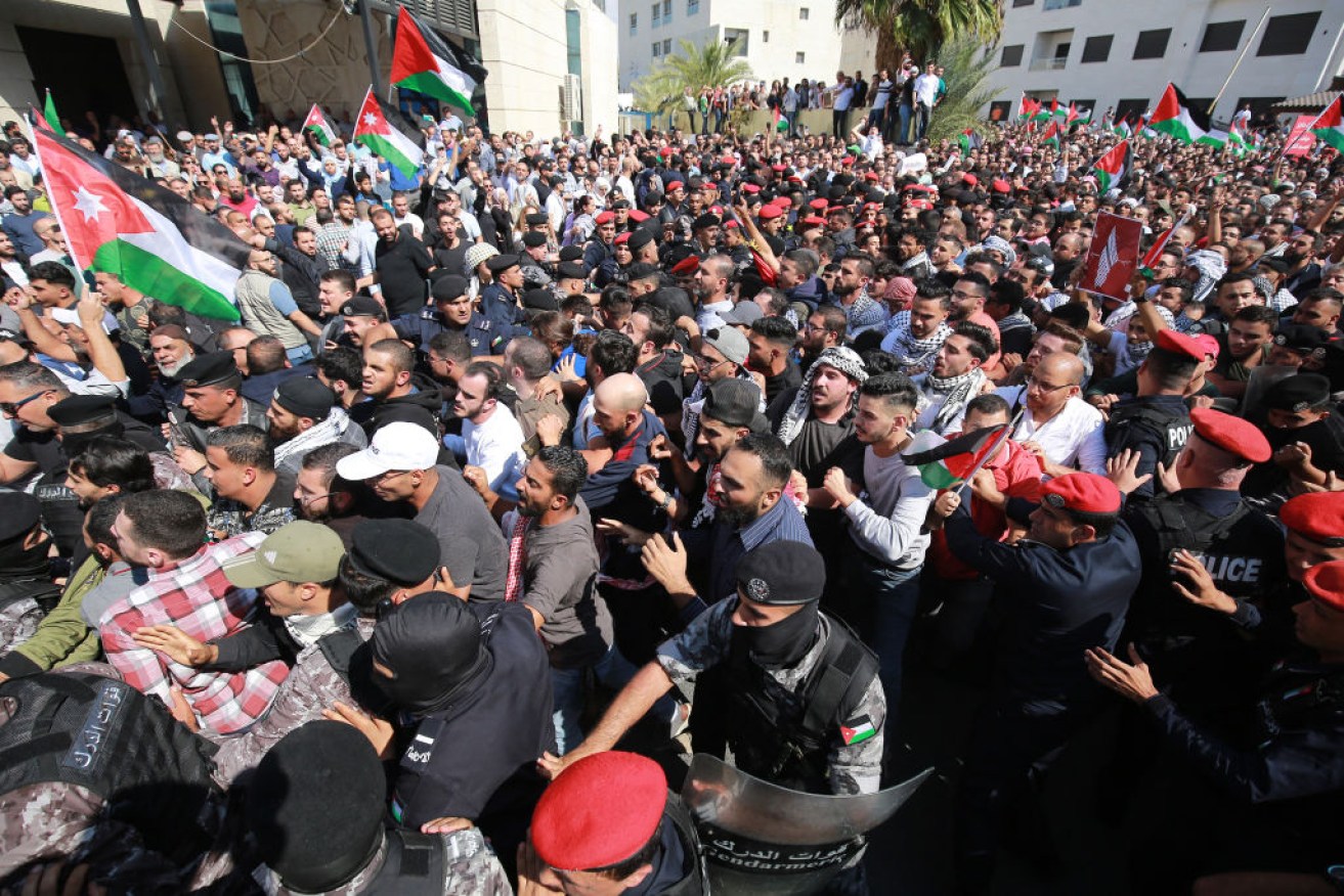 Protesters scuffle with Jordanian police near the Israeli Embassy in Amman on Wednesday.