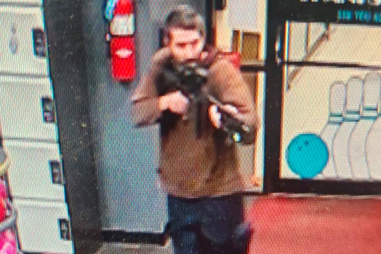 The suspect, pictured in jeans and a long-sleeve shirt, is still on the run.