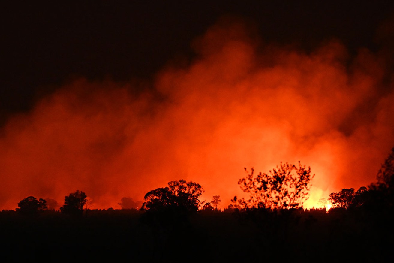 Bushfire, flooding and storm damage are pushing major insurers and banks towards a major financial crisis (AAP Image/Supplied by Queensland Fire and Emergency Services)