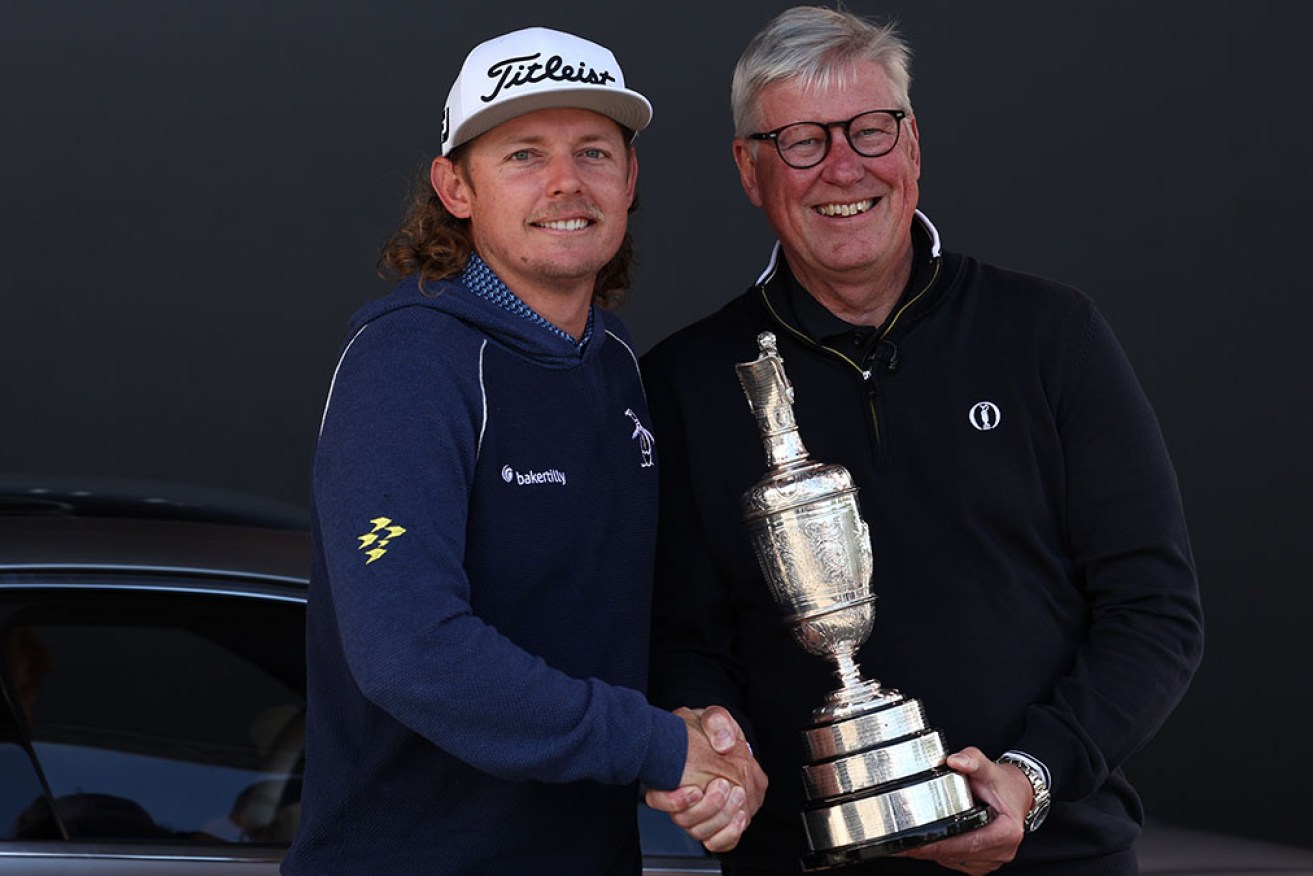 Former British Open winner Cameron Smith returns the Claret Jug to R&A boss Martin Slumbers.