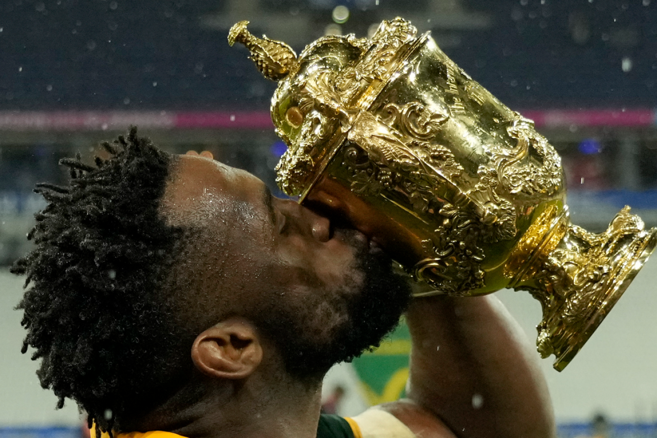 South Africa's Siya Kolisi plants a kiss on the coveted trophy after the tough, tight final contest.