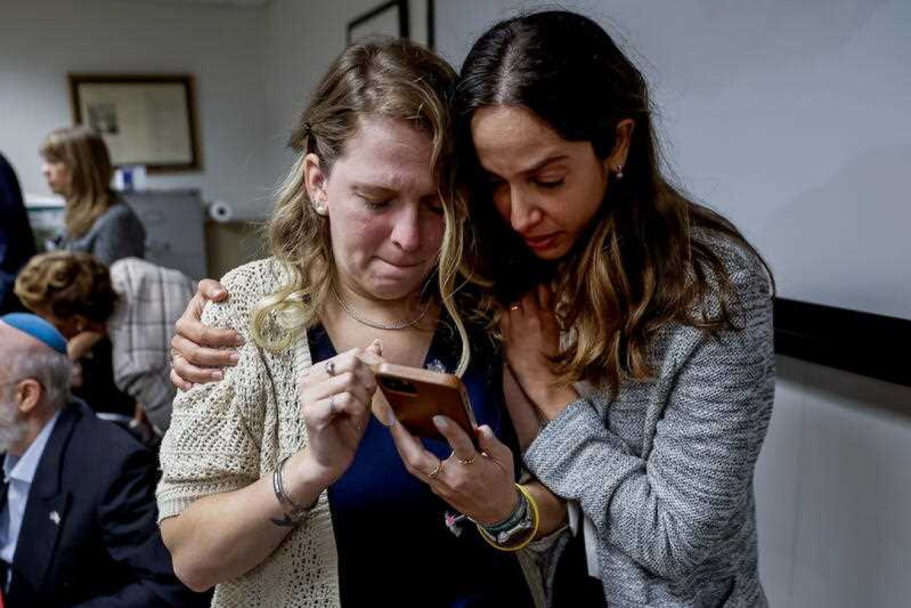 Shani Segal and Dafna Sella watch a Hamas video of hostage Rimon Kirsht, Segal's cousin. 