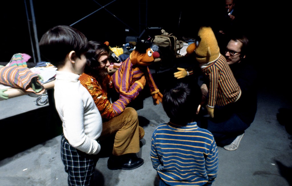 NEW YORK - 1970: Puppeteer Jim Henson (L), holding Ernie, and puppeteer Frank Oz (R), holding Bert, entertain children during rehearsals for an episode of Sesame Street at Reeves TeleTape Studio in March 1970 in New York City, New York. (Photo by David Attie/Getty Images)