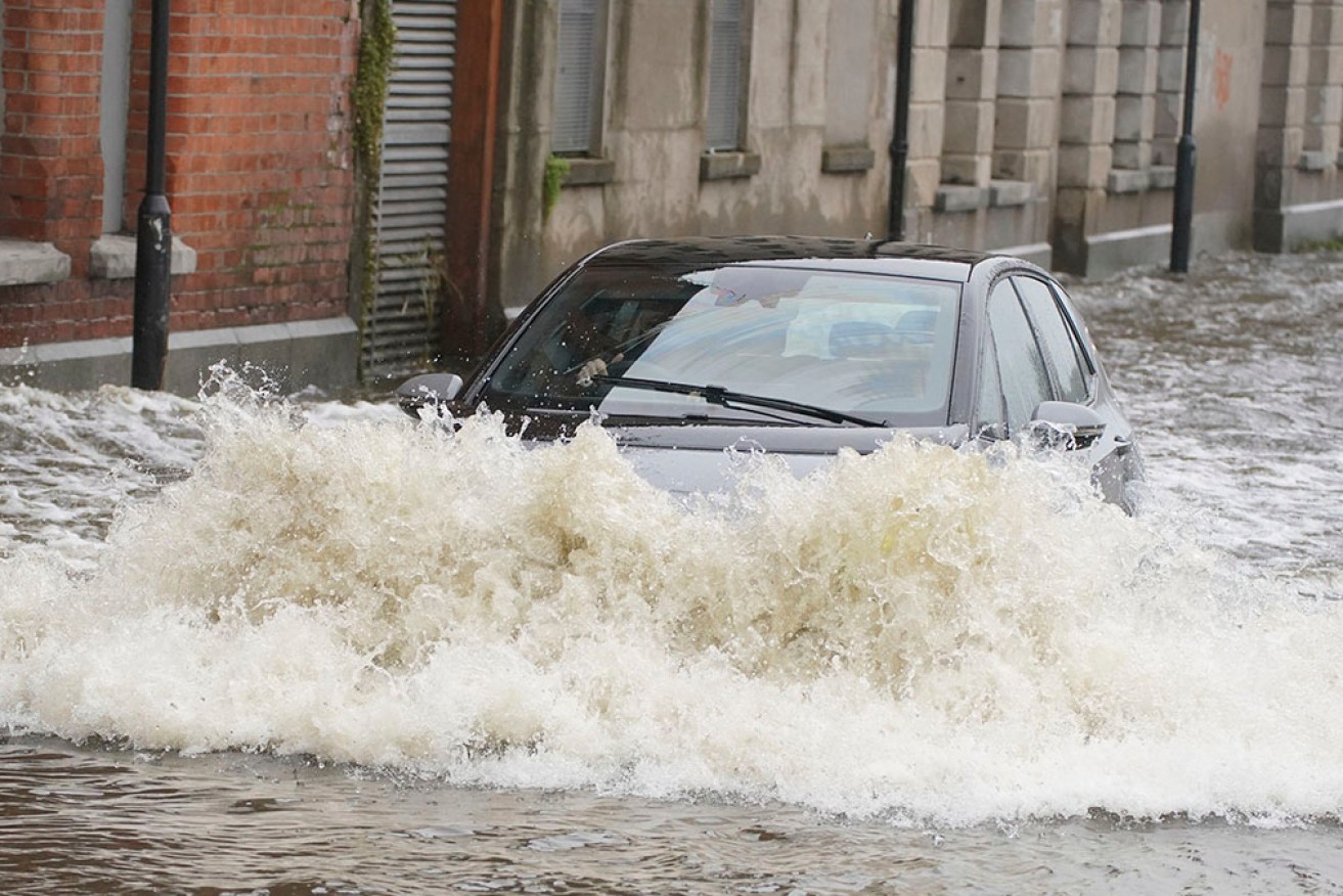 A car drives through flood waters in Newry Town, County Down, Northern Ireland. 