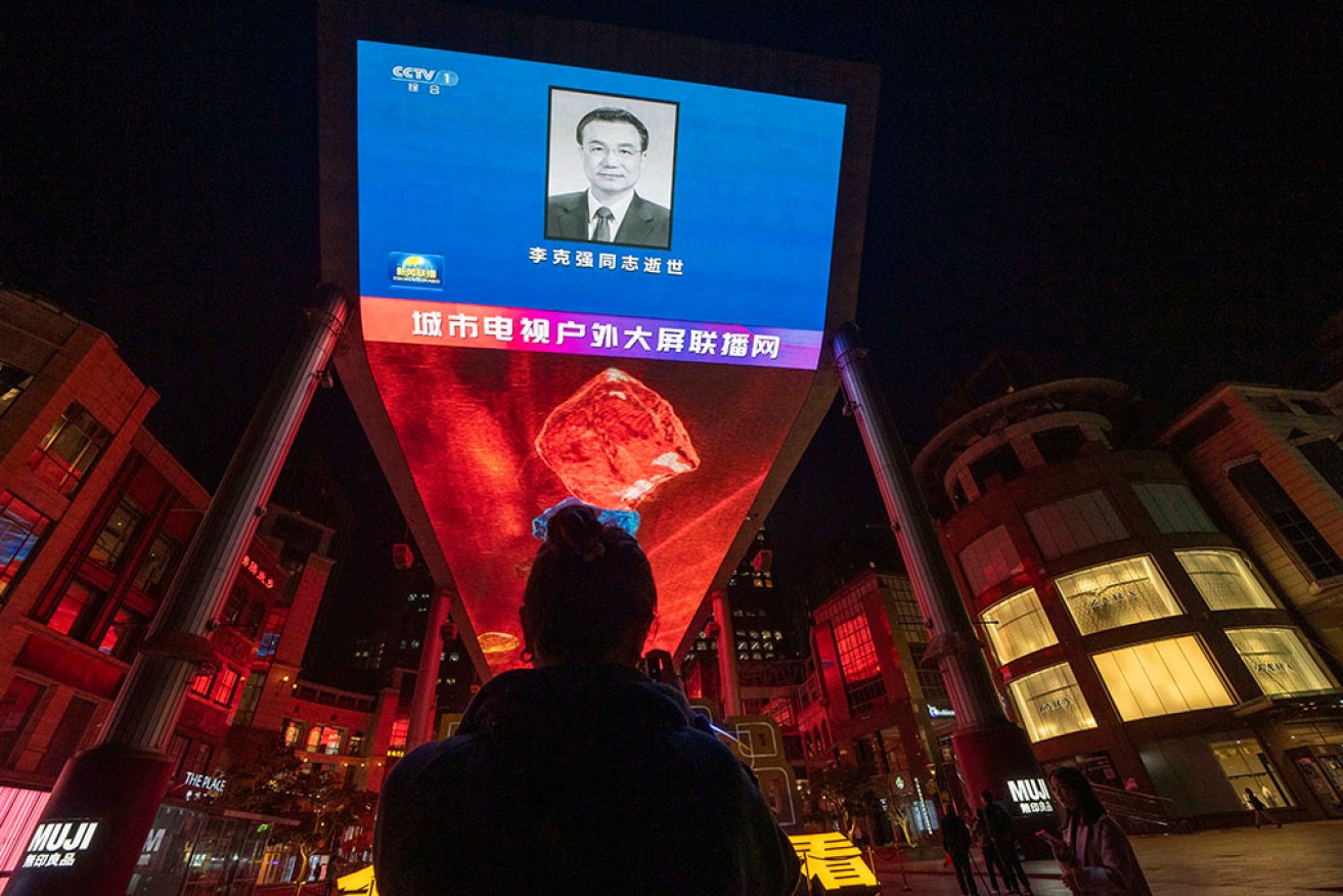 An obituary photo of former Chinese premier Li Keqiang is shown on a giant screen in Beijing.