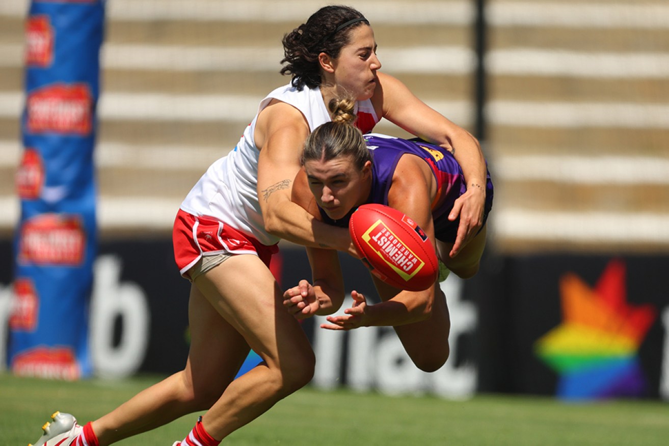 Fremantle’s Emma O'Driscoll manages to get her handball away against Sydney on Sunday. 