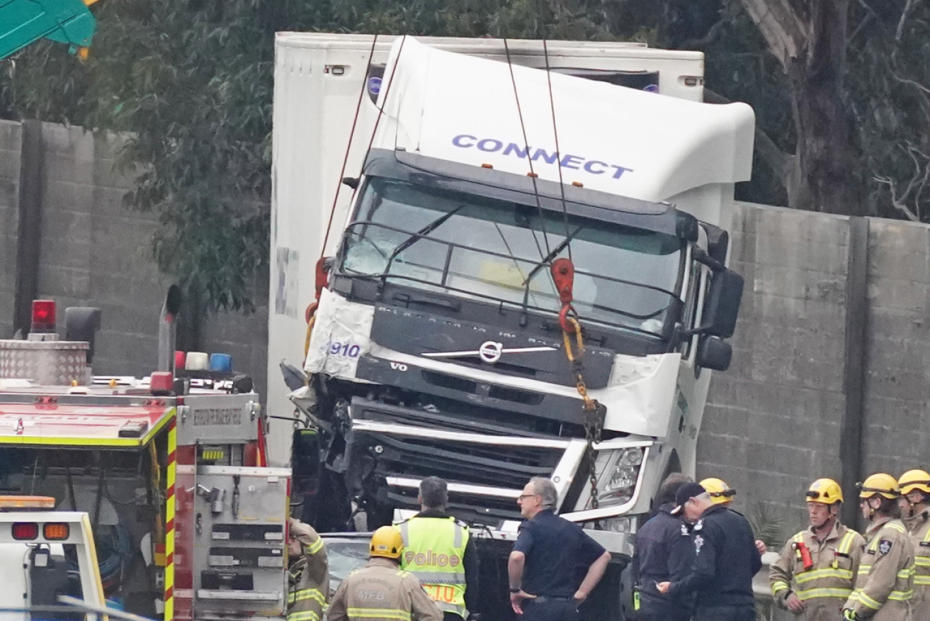 The shattered Connect Logistics truck is lifted off the bodies of the four VicPol officers in April 2020. 