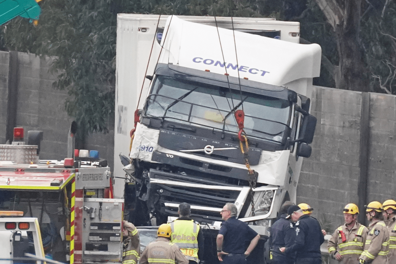 The shattered Connect Logistics truck is lifted off the bodies of the four VicPol officers in April 2020.