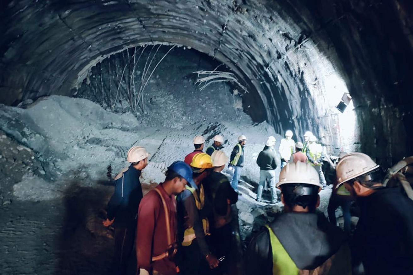 The trapped men are being fed via a narrow pipe pushed through the debris.