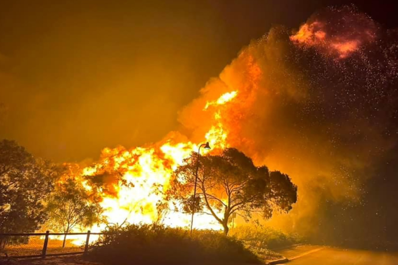 Raging flames erupt into the night sky near Wanneroo in Perth on Saturday.
