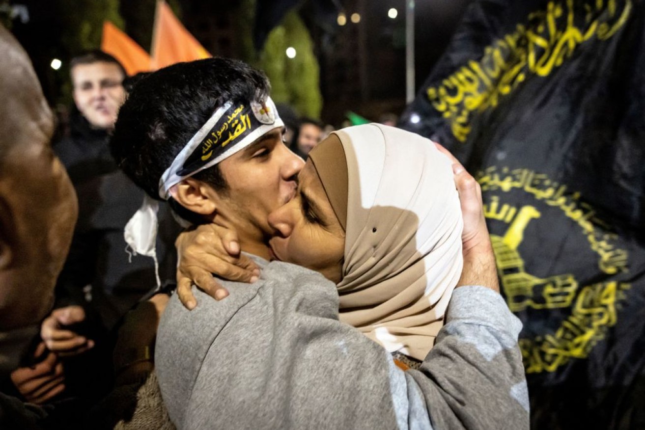 A Palestinian prisoner is embraced after being released from an Israeli jail in exchange for Israeli hostages released by Hamas from the Gaza Strip.